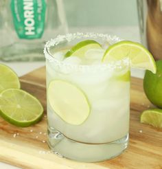 a margarita with limes and sugar on the rim