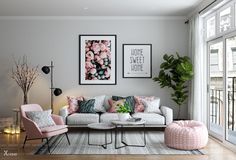 a living room filled with lots of furniture next to a large glass wall window and potted plant