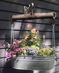 a potted planter with flowers hanging from it's side