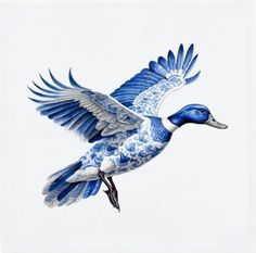 a blue and white bird flying through the air with its wings spread out, it's head turned to the left