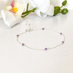 26.00 GBP This beautifully simple bracelet is lovingly handmade with a six tiny Amethyst gemstones and a choice of 14k Gold Filled, 14k Rose Gold Filled or Sterling Silver ​Chain. M A T E R I A L S: • Amethyst • 14k Gold Filled, 14k Rose Gold Filled or Sterling Silver Chain S I Z E: • Gemstones - Approximately 2-3mm • Chain Thickness - Approximately 1.1mm All of our jewellery is carefully handmade using good quality materials and handpicked gemstones, with the aim to produce quality pieces… Dainty Sterling Silver Bracelet With Gemstone, Dainty Sterling Silver Bracelets With Natural Stones, Dainty Sterling Silver Crystal Gemstone Bracelet, Dainty Sterling Silver Gemstone Crystal Bracelet, Dainty Sterling Silver Bracelet For Anniversary, Delicate Amethyst Birthstone Jewelry, Sterling Silver Amethyst Bracelet Gift, Dainty Amethyst Bracelet Jewelry, Dainty Handmade Amethyst Bracelets