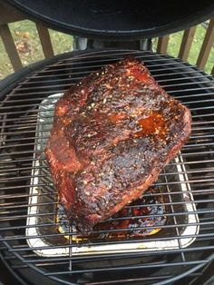 a piece of meat is cooking on the grill