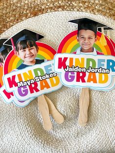 two children's graduation magnets with the words kinder and graduate on them