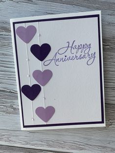 an anniversary card with hearts hanging from it