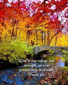 a bridge over a river surrounded by trees with autumn leaves on it and the words god is our refuge and strength, an ever present help in trouble