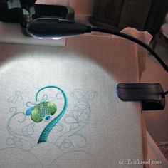 a close up of a sewing machine with the number two embroidered on it