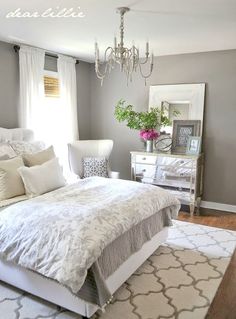 an instagramted photo of a bed in a bedroom with white and gray decor