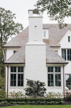 a large white house with a clock tower