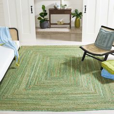 a living room area with a green rug and chair in front of a mirror on the wall