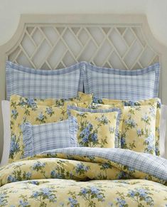 a bed with blue and yellow flowers on it