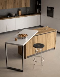 a modern kitchen with an island counter and stools