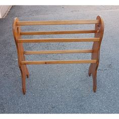 a wooden bench sitting on top of a sidewalk