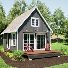 a small gray house with two red chairs on the front porch and an attached deck