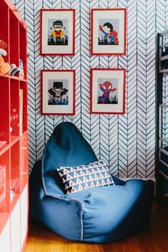 a blue bean bag chair in the corner of a room with pictures on the wall