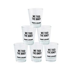 six shot glasses with we tied the knot printed on each one in black and white