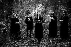 four women dressed in black standing next to each other