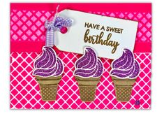 two ice cream cones with purple icing and a sign that says have a sweet birthday