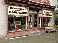 the storefront of rogerson's everything in hardware, with two benches outside