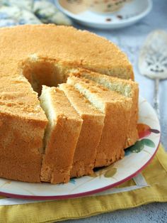 there is a cake that has been cut into pieces and served on a plate with the words vanilla chiffon cake