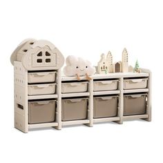 the toy chest is white and has four bins on each side, one with a stuffed animal in it