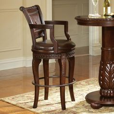 a wooden table with two chairs next to it