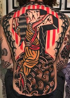 the back of a woman's body with an image of jesus carrying the cross on it