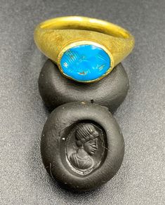 The Beautiful Gold Ring Probably From Ancient Greek's Time With Turquoise Color Blue Glass Stamp. A Beautiful Head Of A Man Figure Engraved On This Blue Glass. Seals Was Mostly Carved In Carnelian Or Garnet In Ancient Times But On Glass Very Rare. We Can Provide Gold Certificate On Customers Request.18 Karat Gold. We Provide Fast And Free Shipping World Wide. Beautiful Gold Rings, Man Figure, Gold Certificate, Jasper Necklace, Carnelian Beads, Old Jewelry, Ancient Times, Turquoise Color, Ancient Greek