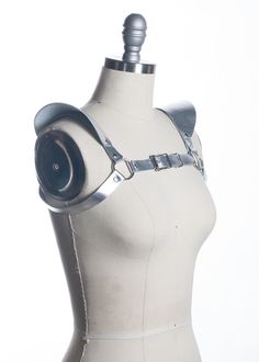 This chestpiece shoulder harness adds drama and impact to any outfit. Epaulette shoulder "wing" details. Show them you mean business! This piece works especially well with dresses and flowing tops that don't have a defined waistline. Silver toned nickel-plated steel hardware. Shown in silver metallic leather (silver leather is now lined and stitched!). Also available in black leather, black vegan leather, and PVC.Buckles in front across chest. All pieces are MADE TO ORDER, standard sizes XS-4XL. Gothic Fitted Harness With Adjustable Straps, Fitted Belt Harness For Cosplay, Fitted Harness With Belt For Cosplay, Epaulettes Fashion, Leather Epaulettes, Diy Body Harness, Wing Harness, Leather Harness Women, Silver Bodysuit