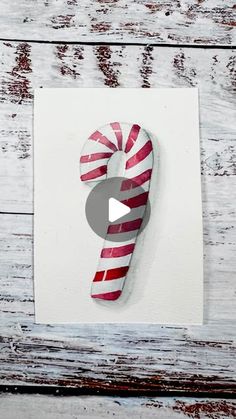 a candy cane on top of a piece of paper