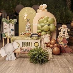 an elephant and giraffe themed birthday party with balloons, decorations, and table cloths