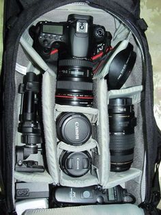 a camera bag filled with many different types of cameras