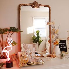 a dresser with a mirror, vases and other items on it