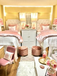 two beds in a room with pink and white decor on the walls, along with other furniture