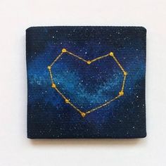 a blue square with yellow stars in the shape of a heart