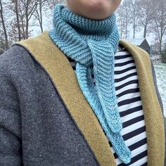 a woman wearing a knitted scarf in the snow