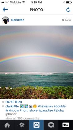 a rainbow appears to be in the sky over water and land, with an instagram message below it