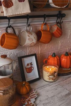 there are many pumpkins and coffee mugs hanging on the wall