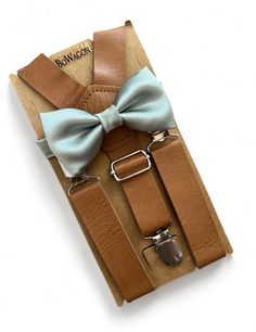 Sage Green Bow Tie and Brown 1 inch wide leather suspenders and bow tie set for groomsman or ring bearer. Size 1-2years old suspenders are up to 25" long. Size 3-6 years old suspenders are up to 30" long Size 7-12 years old  suspenders are up to 33"long.  Size Adult suspenders are 45" long. The regular necktie is 3 1/2" wide, and skinny adult necktie is 2 1/2" wide, 60" long. Please remember that the suspenders are made of elastic and will stretch. They can stretch up to 10 extra inches. We can ship fast... If you have any questions, please message me. WEDDING ORDERS: Please let me know your wedding date to assure I can meet your deadlines. It take about 5 days to make wedding orders.  INTERNATIONAL ORDERS: Please review shipping policies as first class shipping can take up to 2-4 weeks. F Sage Green Bow Tie, Suspenders Groomsmen, Suspenders And Bow Tie, Green Bow Tie, Light Sage Green, Leather Suspenders, Bow Tie Set, Wedding Order, Green Bows