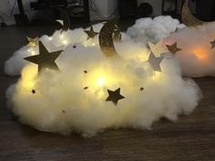 there are stars and moon lights in the clouds on the floor next to each other