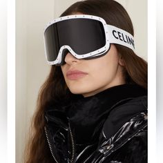 a woman wearing ski goggles with the word celin on it's side