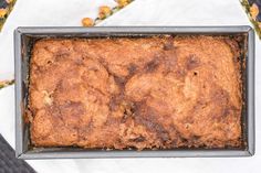 a close up of a cake in a pan on a table with other food items