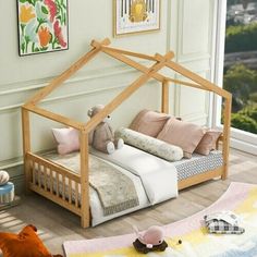 a child's bed with a wooden frame and canopy over the top, in front of a window