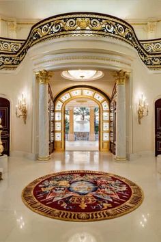 an elaborately decorated entry way leads to the foyer