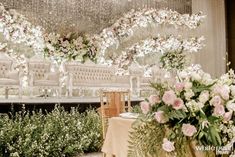 an outdoor wedding setup with white chairs and pink flowers