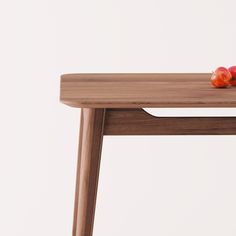 two apples sitting on top of a wooden table