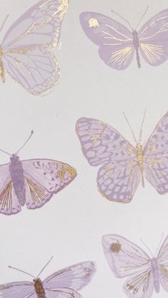 several different types of butterflies on a white surface with gold foiled edges and wings