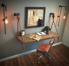 an old fashioned desk with rope hanging from it's sides and a chair next to it