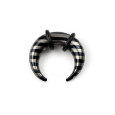 a black and white striped ring with two horns on the front, one is shaped like an elephant's tail