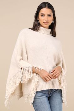 We love to bundle up in style with the Lulus Eclectic Attitude Cream Knit Turtleneck Fringe Poncho Sweater! Super soft and stretchy sweater knit shapes this Boho sweater with a cozy turtleneck and a wide-cut, oversized bodice that boasts poncho-style sleeves with fun fringe trim. Contrasting ribbed knit accents the neckline and split hem. Fit: This garment fits true to size. Length: Size medium measures 23.5" from shoulder to hem. Bust: Great for any cup size. Waist: Not Fitted - comfortable roo One Size Knit Poncho For Fall, Knit Fabrication Poncho For Fall, One Size, Knit Fabrication One-size Poncho For Fall, One-size Knit Sweater With Batwing Sleeves, Fall Layering Knitted Poncho, Fall Knit Poncho For Layering, Knit Poncho For Fall Layering, Cozy Knit Poncho For Fall, Knit Poncho For Cold Weather