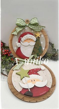 two plates decorated with santa claus and a green christmas tree on the top one is holding a star